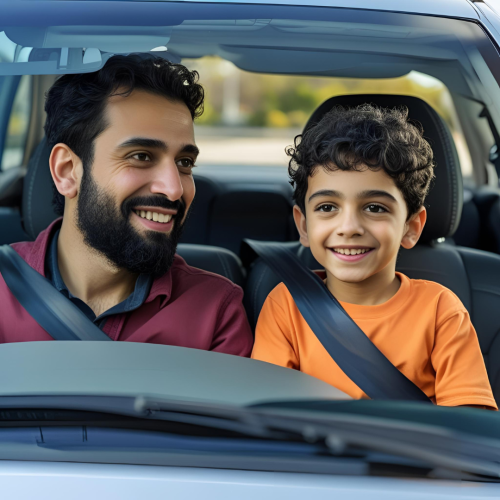 Dad and young boy in a car